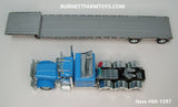 Item #60-1397 Baby Blue Tri-Axle Peterbilt 389 63-inch Flattop Sleeper with Turbo Wing and Silver Deck Silver Frame Spread Axle Transcraft Stepdeck Trailer - 1/64 Scale - DCP by First Gear