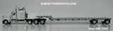 Item #60-1485 White Tri-Axle Peterbilt 389 63-inch Flattop Sleeper with Turbo Wing and Silver Deck White Frame Spread Axle Transcraft Stepdeck Trailer - 1/64 Scale - DCP by First Gear