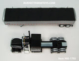 Item #60-1702 Black Silver Stripe Peterbilt 389 63-inch Flattop Sleeper with Silver High Sided Black Tarp Silver Frame Tandem Axle Wilson 43-foot Pacesetter Hopper Bottom Grain Trailer - 1/64 Scale - DCP by First Gear