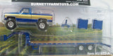 Item #51653-A Blue Gold Silver 1987 Lifted GMC K-2500 Pickup Truck with Toolbox and Blue Tandem Axle Flatbed Gooseneck Trailer with Ramps - 1/64 Scale - Greenlight