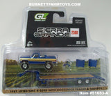 Item #51653-A Blue Gold Silver 1987 Lifted GMC K-2500 Pickup Truck with Toolbox and Blue Tandem Axle Flatbed Gooseneck Trailer with Ramps - 1/64 Scale - Greenlight