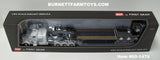 Item #60-1476 White Black and Gray Flame Tri-Axle Peterbilt 389 63-inch Flattop Sleeper with Black Tri-Axle Fontaine Magnitude Lowboy Trailer with Flip Axle and Detachable Neck - 1/64 Scale - DCP by First Gear