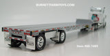 Item #60-1485 White Tri-Axle Peterbilt 389 63-inch Flattop Sleeper with Turbo Wing and Silver Deck White Frame Spread Axle Transcraft Stepdeck Trailer - 1/64 Scale - DCP by First Gear