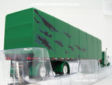 Item #60-1607 Green Black Gray Peterbilt 359 63-inch Mid Roof Sleeper with Green Black Gray Sided Black Frame Spread Axle Utility Roll Tarp Flatbed Trailer - 1/64 Scale - DCP by First Gear