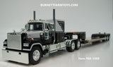 Item #60-1669 Light Gray Black Mack Superliner 60-inch Flattop Sleeper with Black Fontaine Renegade LXT40 Lowboy Machinery Trailer with Flip Axle and Detachable Neck - 1/64 Scale - DCP by First Gear