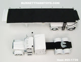 Item #60-1739 White Black Frame Peterbilt 389 63-inch Mid Roof Sleeper with White Sided Black Tarp White Frame Spread Axle MAC Round Dump Trailer - 1/64 Scale – DCP by First Gear