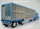 Item #60-1787 Baby Blue White Stripe Black Outline Long Frame Peterbilt 389 63-inch Mid Roof Sleeper with Silver Sided Baby Blue Trim Spread Axle Wilson Silver Star Livestock Trailer - 1/64 Scale - DCP by First Gear