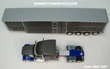 Item #60-1897 Gun Metal Gray Blue White Outline Kenworth W990 76-inch Mid Roof Sleeper with Gun Metal Gray Sided Silver Trim Quad Axle Wilson Silver Star Livestock Trailer - 1/64 Scale – DCP by First Gear