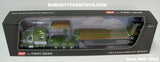 Item #60-1922 Olive Green Metallic White Black Stripe Peterbilt 389 70-inch Mid Roof Sleeper with Olive Green Metallic Tandem Axle Fontaine Renegade Machinery Trailer with Flip Axle - 1/64 Scale – DCP by First Gear