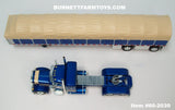 Item #60-2030 Galaxy Blue Tan Peterbilt 379 36-inch Flattop Sleeper with Galaxy Blue Sided Tan Tarp Galaxy Blue Frame Spread Axle Wilson Roadbrute 53-foot Flatbed Covered Wagon Trailer - 1/64 Scale – DCP by First Gear