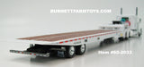 Item #60-2033 White Peterbilt 389 63-inch Flattop Sleeper with White Landoll 440 Series Traveling Slide Axle Flatbed Trailer - 1/64 Scale – DCP by First Gear