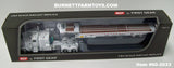 Item #60-2033 White Peterbilt 389 63-inch Flattop Sleeper with White Landoll 440 Series Traveling Slide Axle Flatbed Trailer - 1/64 Scale – DCP by First Gear