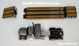 Item #60-2160 Gun Metal Gray Metallic Black Stripe Orange Outline Peterbilt 379 48-inch Mid Roof Sleeper with Black Tandem Axle Fontaine Renegade Machinery Trailer - 1/64 Scale – DCP by First Gear