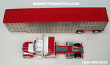 Item #60-2229 White Red Burgundy Swoop Stripe Peterbilt 379 63-inch Mid Roof Sleeper with Silver Red Trim Spread Axle Wilson Silver Star Livestock Trailer - 1/64 Scale – DCP by First Gear