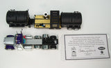 Item #69-2065 Larson Farms Silver Purple Tri-Axle Peterbilt 379 Day Cab with Black Tandem Axle DEMCO 42-foot Liquid Tender Trailer with Deluxe Plumbing Package - 2025 National Toy Truck 'N Construction Show Edition - 1/64 Scale – DCP by First Gear