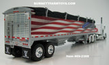 Item #69-2368 White Peterbilt 389 48-inch Flattop Sleeper with American Flag High Sided Black Tarp Silver Frame Tandem Axle Wilson Pacesetter 43-foot Hopper Bottom Grain Trailer - USA 250 Year Anniversary Edition - 1/64 Scale – DCP by First Gear