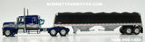 Item #60-1460 Blue Silver Gold Peterbilt 389 63-inch Flattop Sleeper with Black Sided Black Tarp Silver Frame Tandem Axle Wilson Commander Hopper Bottom Grain Trailer with Chrome End Caps - 1/64 Scale - DCP